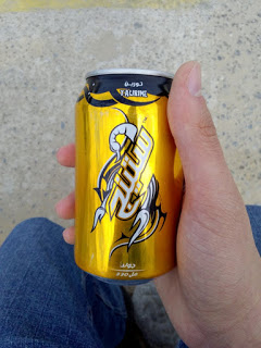 A guy holding a can of energy drink